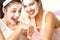 Caucasian girls wearing peeling mask having fun