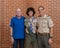 Caucasian grandfather, father and teenage Amerasian son after a ceremony for Eagle Scout recognition in Edmond, Oklahoma.