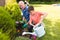 Caucasian grandfather and grandson spending time together in the garden, planting