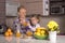 Caucasian grandmother standing behind the kitchen counter with her granddaughter