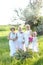 Caucasian grandmother standing with daughters and granddaughter outside.