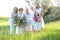 Caucasian granny standing with daughters, granddaughters and grand granddaughter outside.