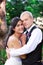 Caucasian groom holding his biracial bride, smiling. Diverse couple.