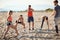 Caucasian group of two men and three women stretching, warming up for exercising at  beach