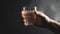 Caucasian hand holding glass pouring dark whiskey generated by AI