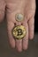 Caucasian hands shows one Bitcoin coin and one Euro Coin. New finance concept. Comparison between currencies, fiat and crypto