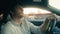 Caucasian handsome driver man businessman safe driving car on city road confident male guy riding automobile electric