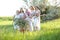 Caucasian happy granny standing with daughters, granddaughters and grand granddaughter outside.