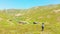 Caucasian hiker in scenic mountains enjoy stunning panorama of Shuamta village. Happy travel inspirational adventure