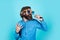 caucasian hipster with beard and stylish hair in arty glasses with microphone, speaker