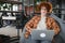 Caucasian hipster guy enjoying distance job in coffee shop, male freelancer in trendy glasses sitting in cafeteria with