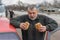 Caucasian hungry senior driver ready to eat street food near his car