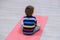 Caucasian kid exercising on yoga mats in gym, children sport