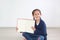 Caucasian kid sitting in room and holding blank page of book. Portrait asian little kid girl open book