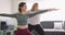 Caucasian lesbian couple keeping fit and practicing yoga on mat