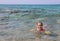 Caucasian littl girl swiming on the sea in summer