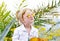 Caucasian Little Blond Girl Walking Tropical Garden