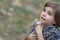 Caucasian little boy in a summer hat outdoors