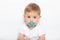 Caucasian Little child boy and plastic baby soother pacifier