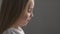 Caucasian little girl close-up drinks milk from a glass