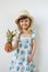 Caucasian Little Girl in Hat Hold Juicy Mini Pineapple Hands