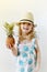 Caucasian Little Girl in Hat Hold Juicy Mini Pineapple Hands