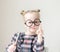 Caucasian little girl with round glasses. Little teacher