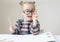 Caucasian little girl with round glasses. Little teacher