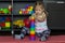 Caucasian little girl of three years old building pyramid using colorful stacking cups