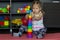 Caucasian little girl of three years old building pyramid using colorful stacking cups