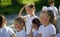 Caucasian little girls team with painted faces playing in summer park