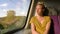 Caucasian look woman admires the view through the train window. Sweet face female enjoyes her vacation trip. Blond hair