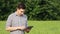 The caucasian male brunette farmer on the field works with a tablet. Scientist working in the field with agricultural