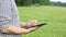 The caucasian male brunette farmer on the field works with a tablet. Scientist working in the field with agricultural