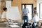 Caucasian male coach make whiteboard presentation to diverse employees