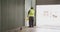 Caucasian male factory worker at a factory  with a high vis vest, closing warehouse doors