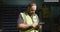 Caucasian male factory worker at a factory wearing a high vis vest working