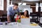 Caucasian male and female business colleague in discussion at desk in office, looking at laptop