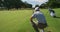 Caucasian male golfer kneeling on a golf course on a sunny day