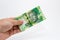 A Caucasian male hand holding a 10 Rand South African note. This image has a plain background