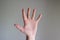 Caucasian male hand making generic gesture. Close up shot, opened palm, isolated on gray background