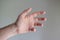 Caucasian male hand making generic gesture. Close up shot, opened palm, isolated on gray background