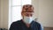 Caucasian male healthcare professional in a hospital operating theatre wearing a surgical cap and mask. Physician in Lab