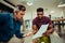 Caucasian male helping colleague in preparation for presentation in front of boss and corporate