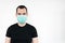 Caucasian male man young. stand at white background, wear mask on face,   protect yourself and save lifes,  closeup. Coronavirus.