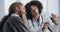 Caucasian male patient experiencing toothache, sitting at dentist of African woman doctor, receiving consultation. Two