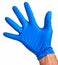 Caucasian male right hand in blue latex glove.