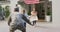 Caucasian male soldier greeting happy son and wife with welcome home sign outside their house