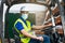 Caucasian male wearing a protective mask driving the forklift through a factory