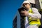 Caucasian male worker at a construction site. Architectural design is holding a laptop at a construction site, checking plans.